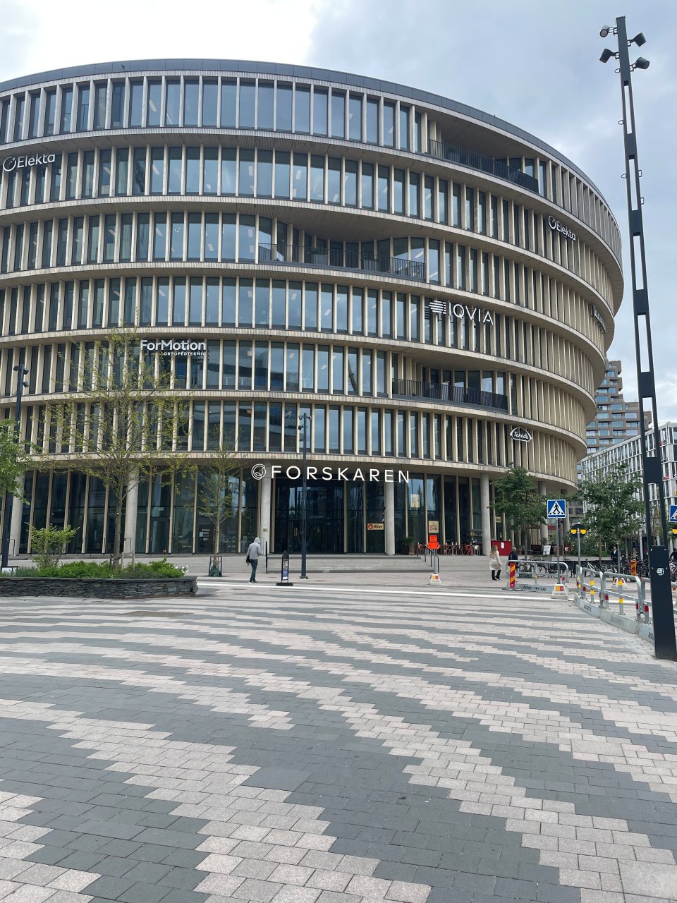 Depicted is a large, round building in a frontal view.