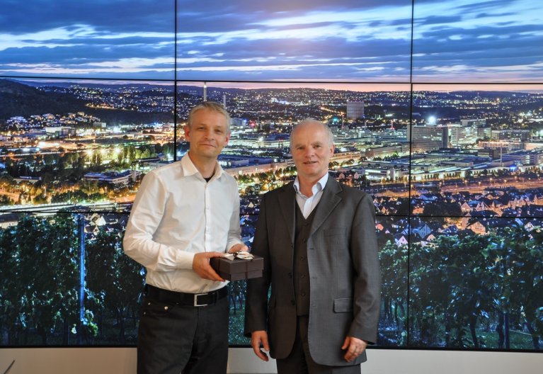 Dr. Hinrich Habeck (links im Bild) übergibt ein kleines Geschenk an Dr. Georg Kääb (rechts im Bild).