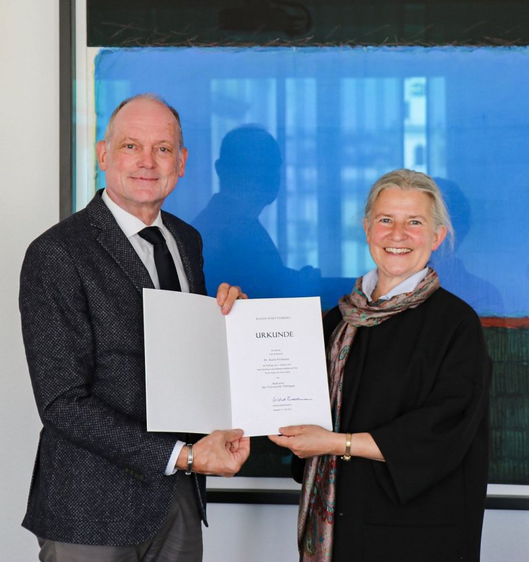 Bild mit dem Ministerialdirektor Dr. Hans J. Reiter, der der Prof. Dr. Karla Pollmann die Urkunde als neue Rektorin an der Universität Tübingen übergibt